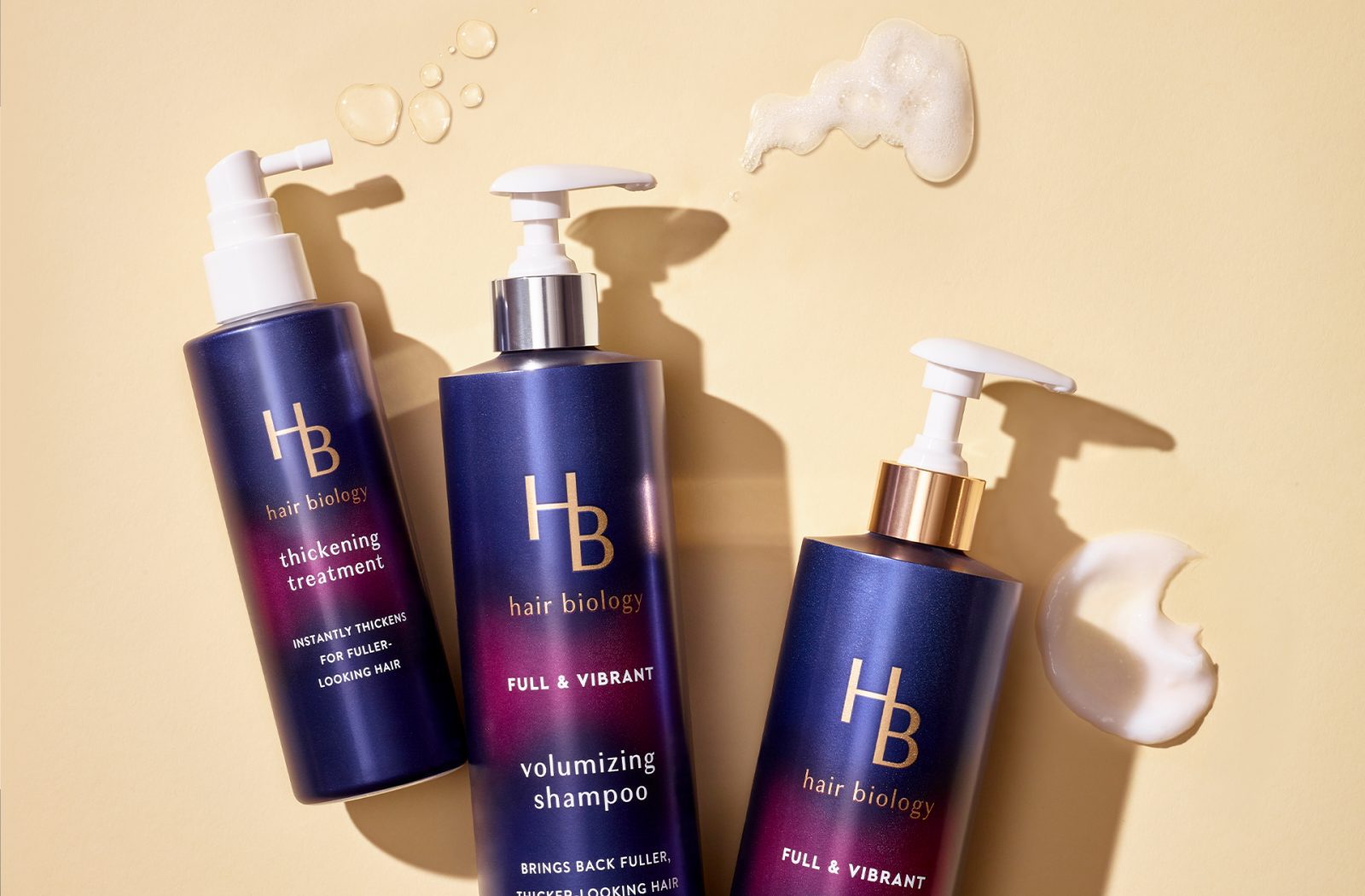 Product photography of three different Hair Biology hair care products, featuring packs created by a cpg packaging design agency.