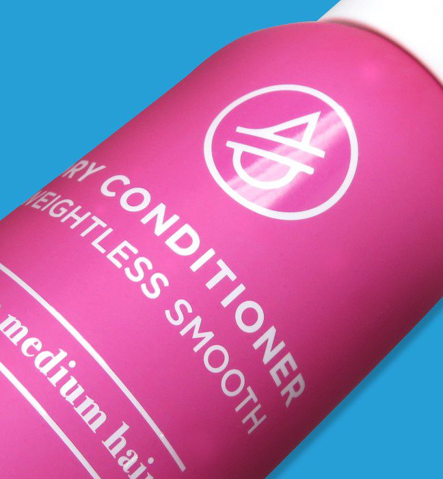 Close up photograph of a bottle of Waterless hair care product, showcasing Cpg packaging design services.