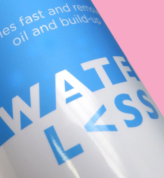 Close up photograph of a bottle of Waterless hair care product, showcasing packaging design services for consumer packaged goods.