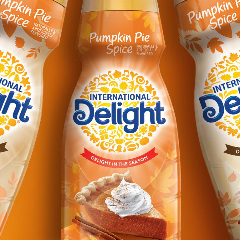 Product photography of three pumpkin spice seasonal variant for international delight coffee creamer, showcasing Cpg packaging design services.