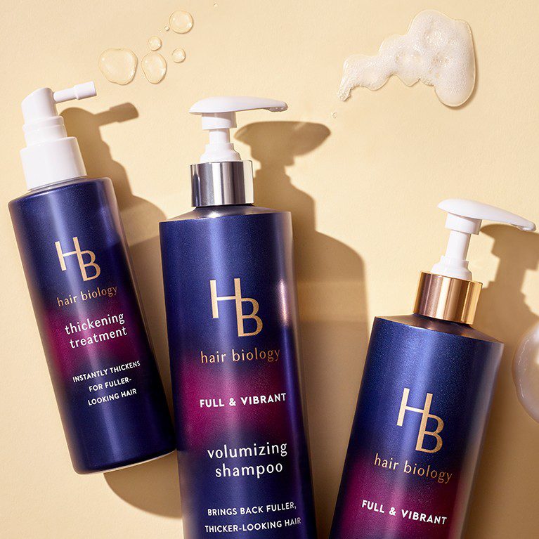 Product photography of three different Hair Biology hair care products, featuring packs created by a cpg packaging design agency.