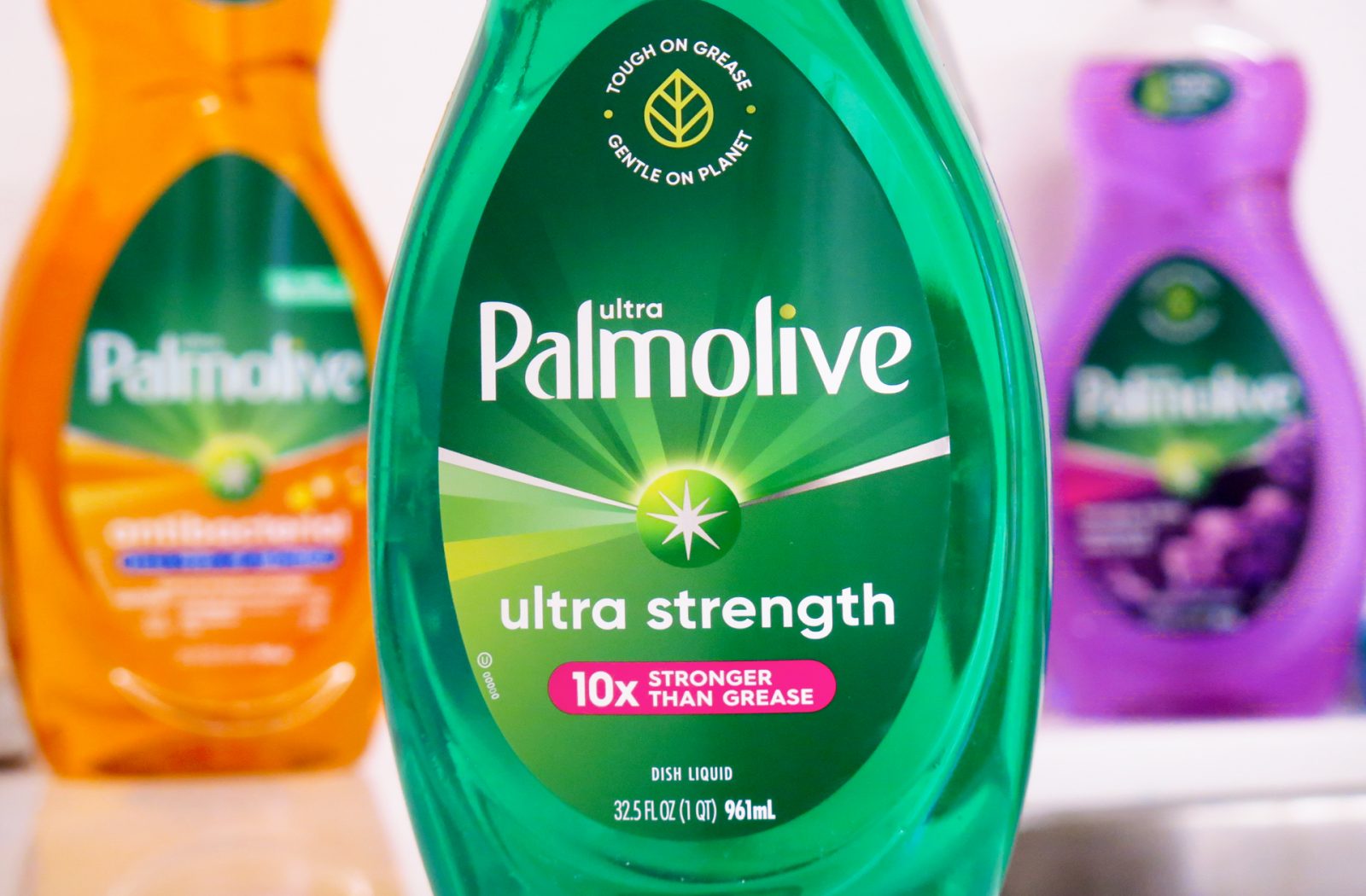 Close up photograph of a bottle of ultra strength palmolive dish soap, featuring a cold foil print technique used to create sales samples by a product packaging printing agency.