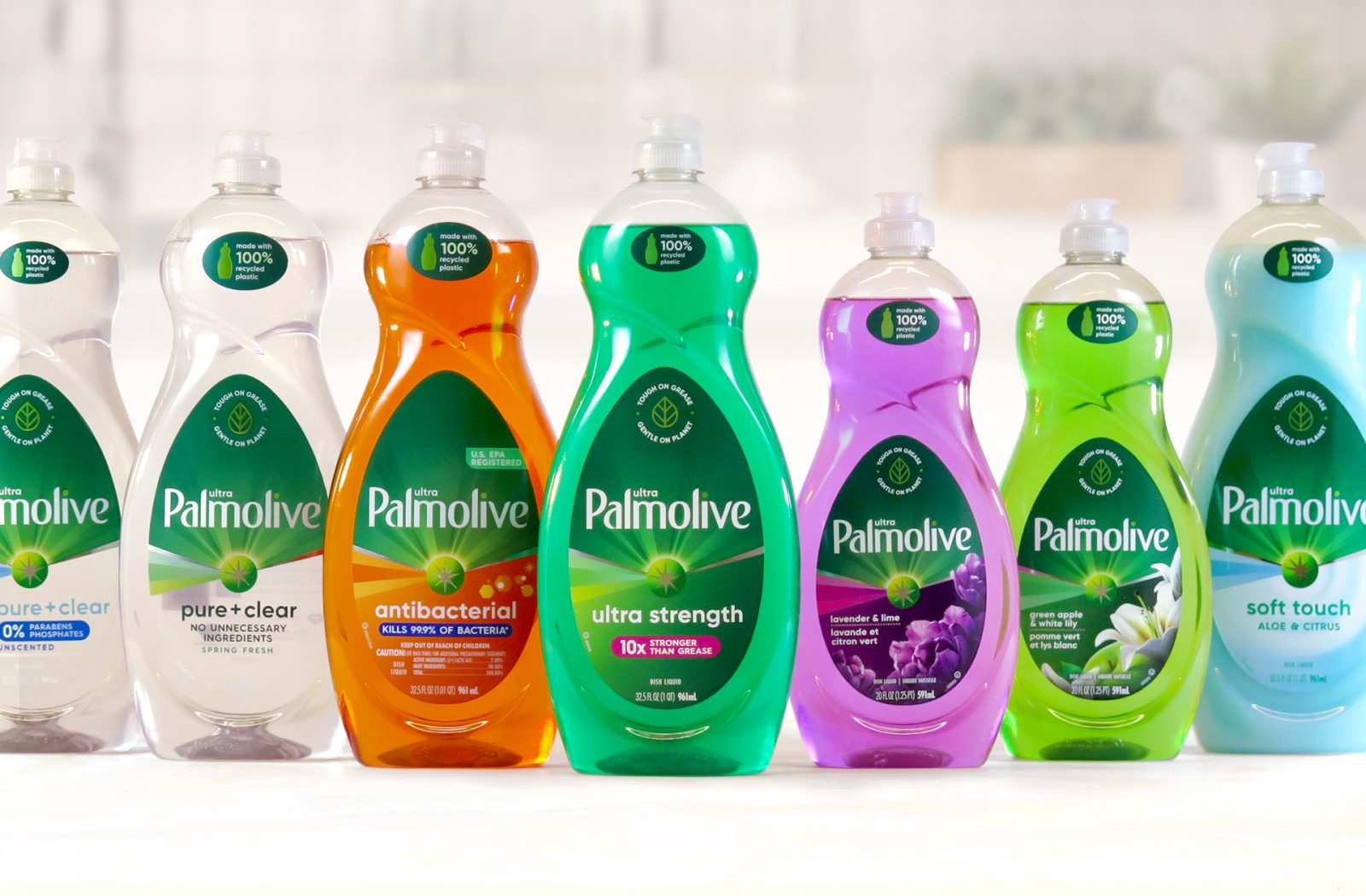 Photograph of a full product line of palmolive dish soap bottles, featuring print targets across seven distinct variants of sales samples created by a cpg packaging production agency.