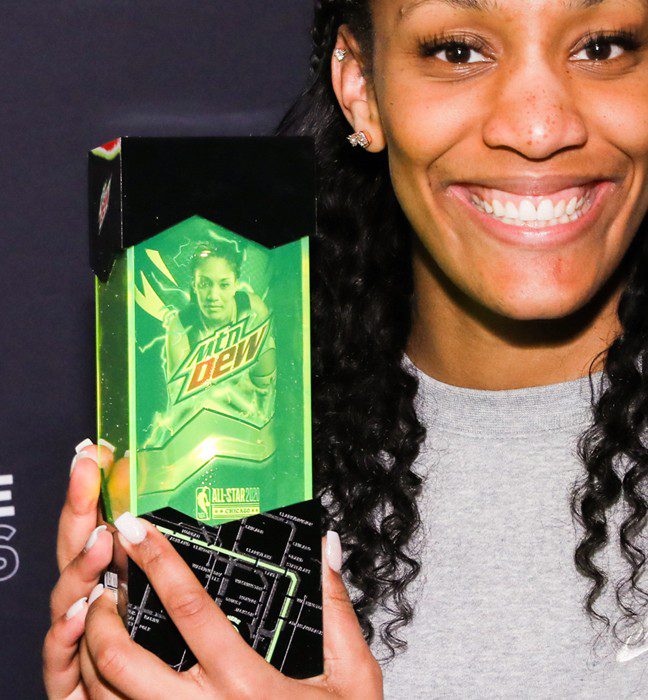 Photograph of a NBA All-star player holding the influencer unboxing experience for the Mountain Dew Basketball limited edition cans featuring NBA All-Stars.