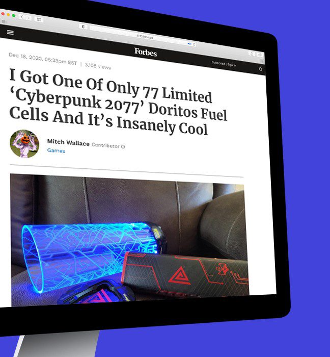 Photograph of a Forbes news article reviewing a fuel cell themed influencer unboxing experience promoting Cyberpunk 2077 and Doritos.