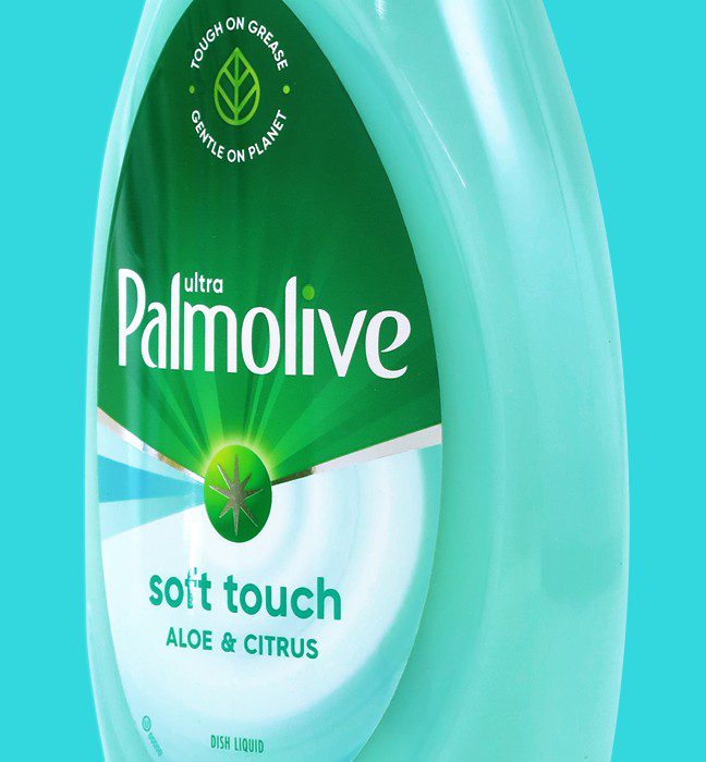 Close up photograph of a bottle of soft touch palmolive dish soap, featuring a vector design system used to create sales samples by a cpg production agency.