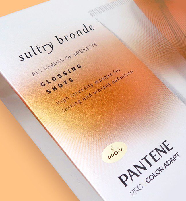 Close up photograph of comps created for Pantene premium collection sales samples, featuring cold foil, metallic inks & varnishes.