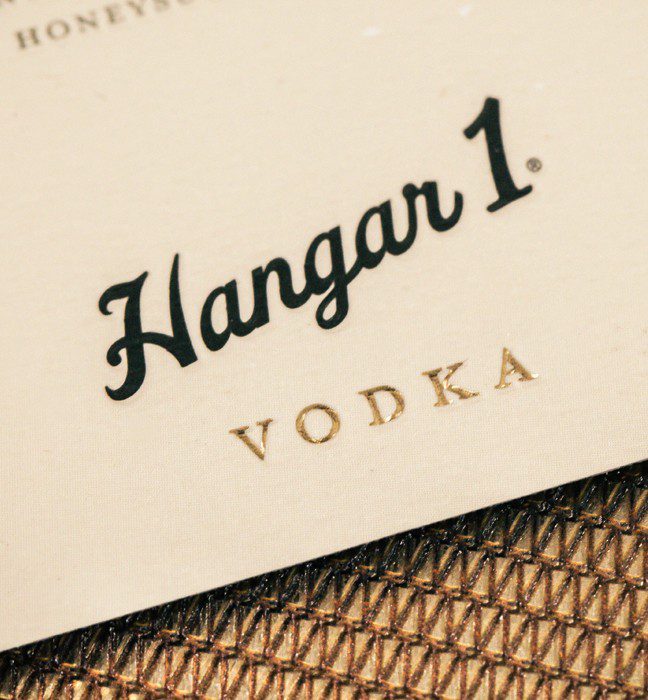 Close up photograph of an fog point Hangar 1 vodka bottle label, featuring unique paper stock.