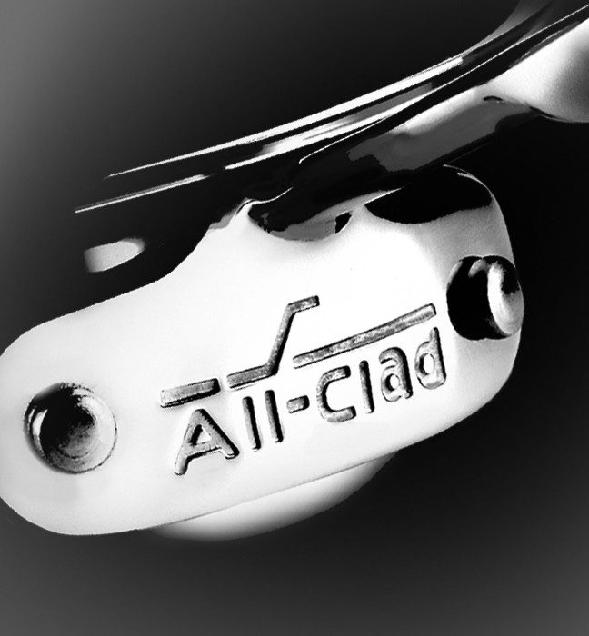 Close up photograph of the All-clad metalcrafters logo on cookware.