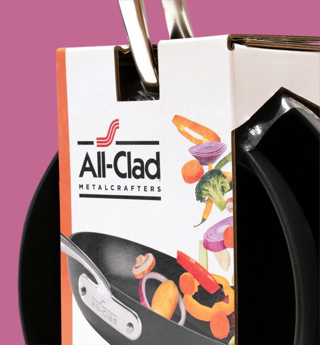 Close up photograph of an All-Clad fry pan, featuring packs created by a cpg packaging design agency.