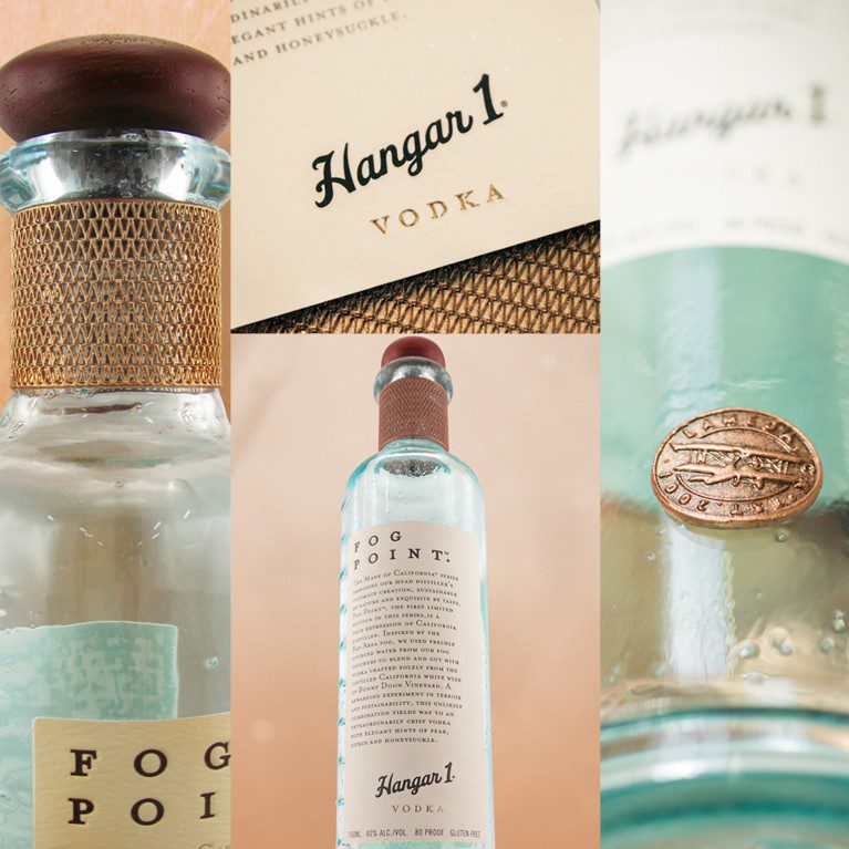 Product photography of fog point Hangar 1 vodka bottles, displaying unique paper stock, hand blown glass, wood and cork closures, and featuring dimensional badges and neck features.