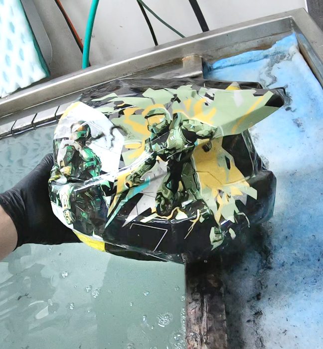 Photograph from the production process for a limited edition illustrated Master Chief helmet created as an influencer unboxing experience promoting Rockstar Energy and Halo Infinite.