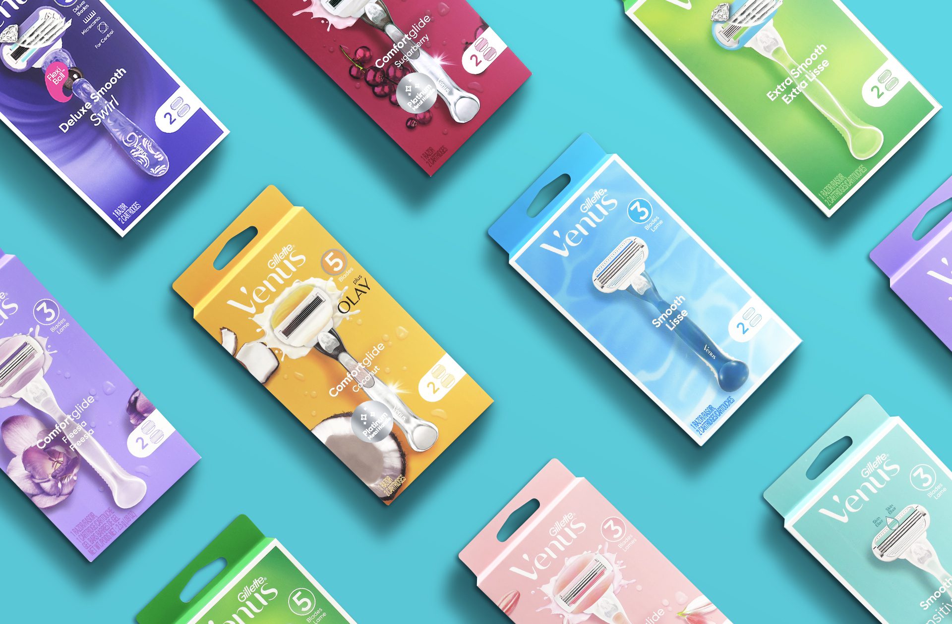 Photograph of a full product line of Gillette Venus including smooth, comfortglide and deluxe smooth razors and cartridges, showcasing brand identity design services for consumer packaged goods.