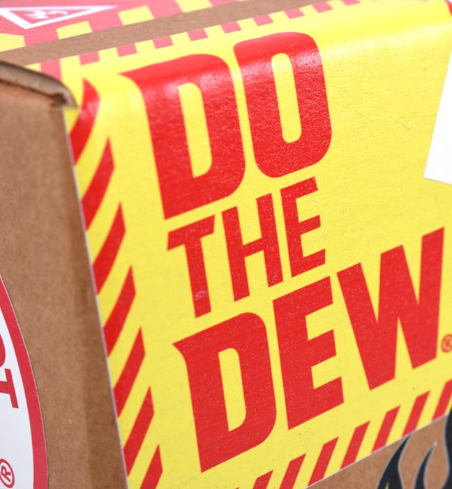 Close-up shot of a unique corrugate shipper outfitted with the brands iconic logos, phrases and mascot created for the influencer unboxing experience kits promoting the limited edition flavor FLAMIN HOT Mountain Dew.