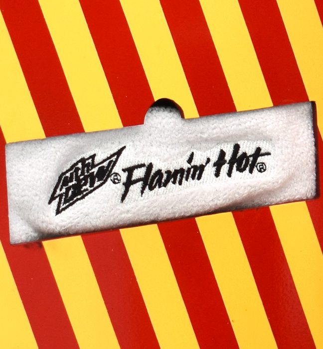 Close-up shot of a custom headband included with the influencer unboxing experience kits promoting the limited edition flavor FLAMIN HOT Mountain Dew.