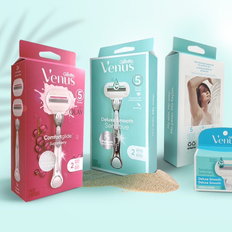 Product photography of different packs of Gillette Venus comfortglide and deluxe smooth razors, showcasing showcasing Cpg packaging design services.