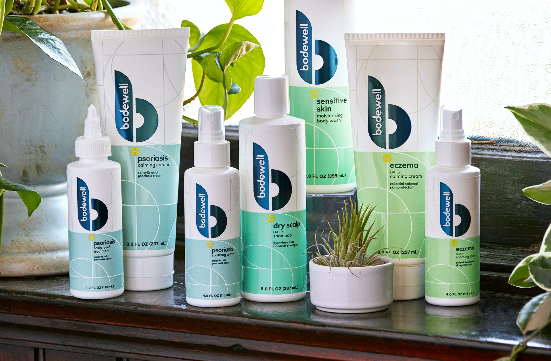 Photograph of a full product line of Bodewell haircare products after a rebrand, showcasing cleaner coloring, use of metallic foils and inks.