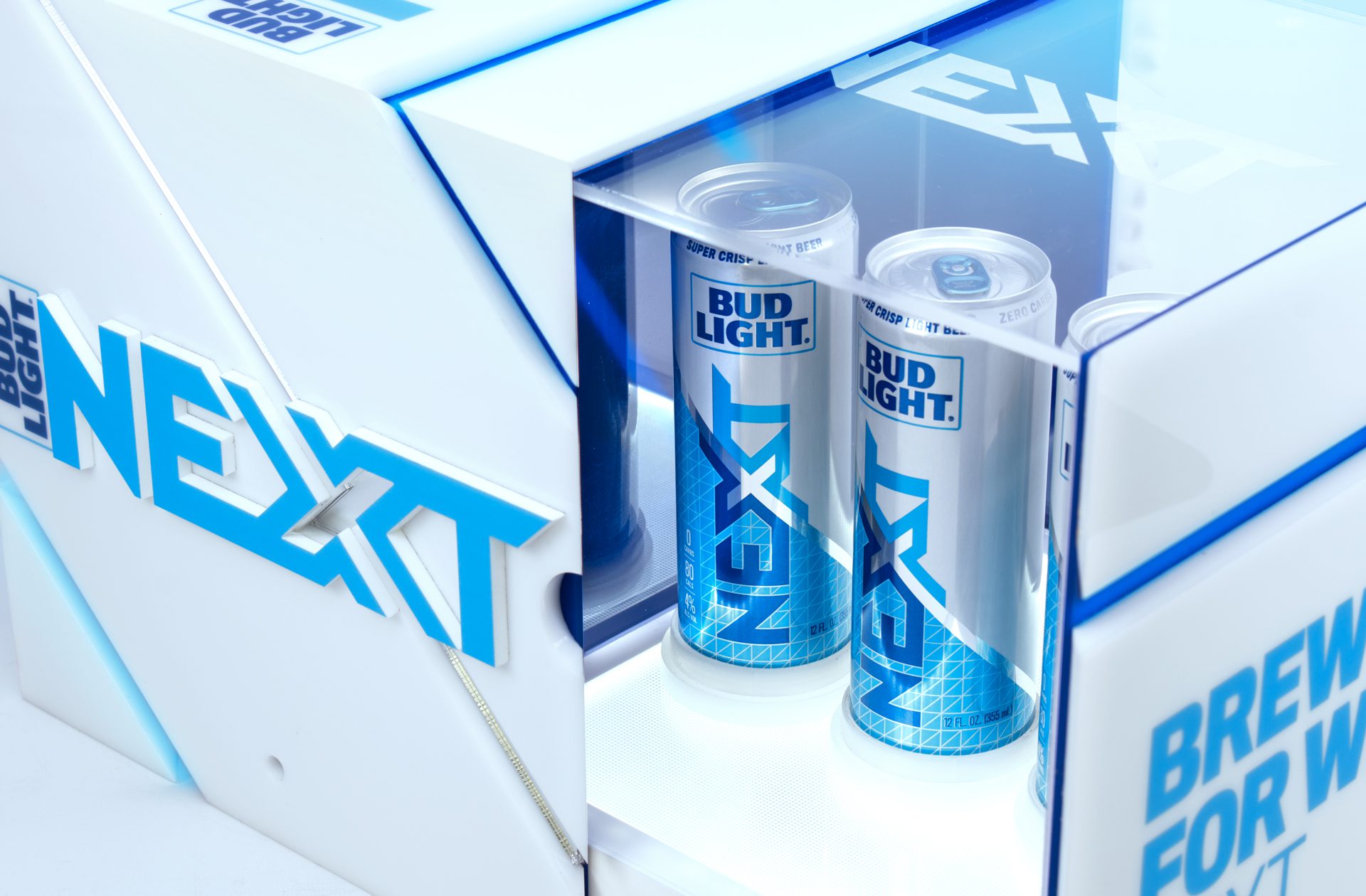 Close-up shot of a brand activation kit & influencer unboxing experience promoting the launch of BUD LIGHT NEXT, opening up to reveal three cans of bud light next.
