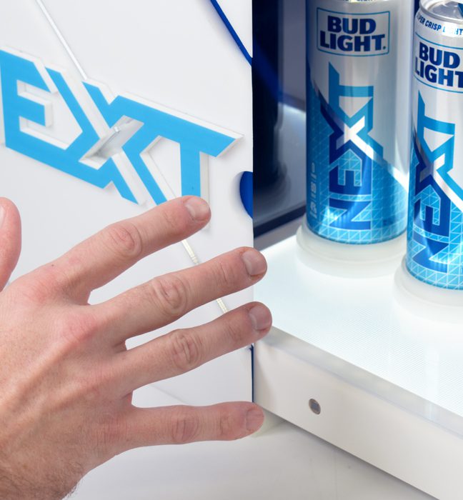 Close-up photograph of a hand reaching out for a brand activation kit & influencer unboxing experience promoting the launch of BUD LIGHT NEXT.