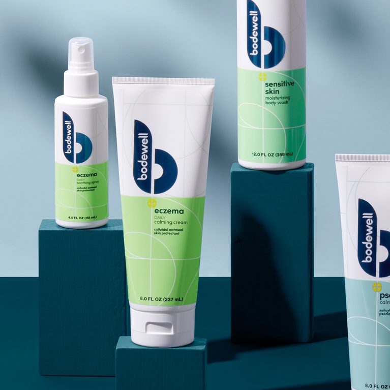Photograph of a full product line of Bodewell haircare products after a rebrand, showcasing showcasing cleaner coloring, use of metallic foils and inks.