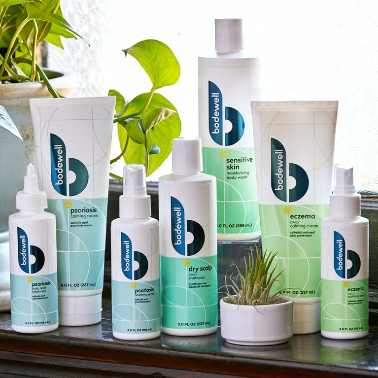 Photograph of a full product line of Bodewell haircare products after a rebrand, showcasing cleaner coloring, use of metallic foils and inks.