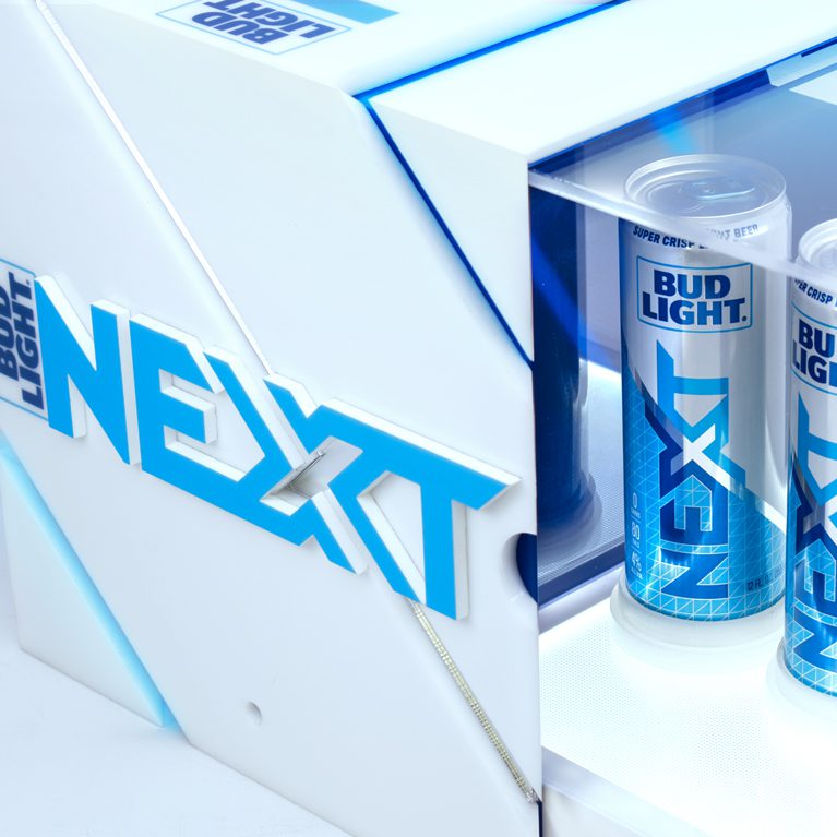 Close-up shot of a brand activation kit & influencer unboxing experience promoting the launch of BUD LIGHT NEXT, opening up to reveal three cans of bud light next.