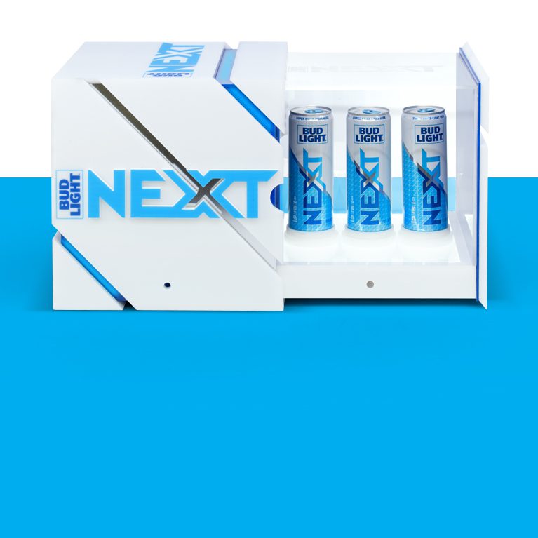 Photograph of a brand activation kit & influencer unboxing experience promoting the launch of BUD LIGHT NEXT, opening up to reveal three cans of bud light next.