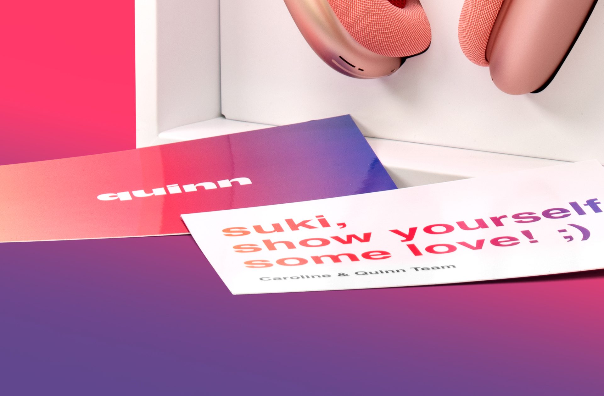 Close-up shot of the pink Quinn headphones inside an Influencer Unboxing Experience for the Quinn app, with a custom printed note on a gradient.