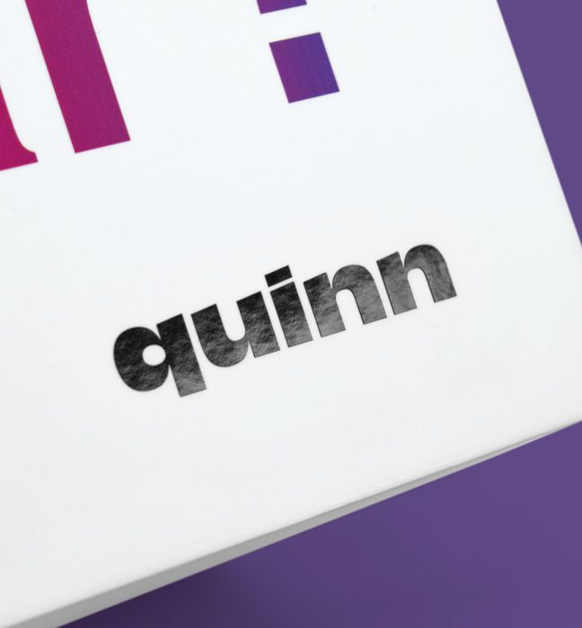 Close up shot of the Quinn logo printed on an Influencer Unboxing Experience for the Quinn app.