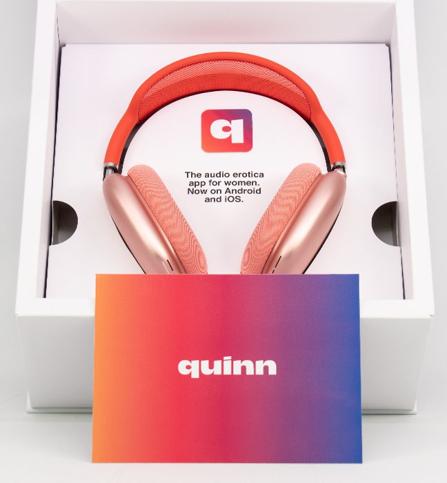 Photograph of the pink Quinn headphones inside an Influencer Unboxing Experience for the Quinn app, with a custom printed note on a gradient.