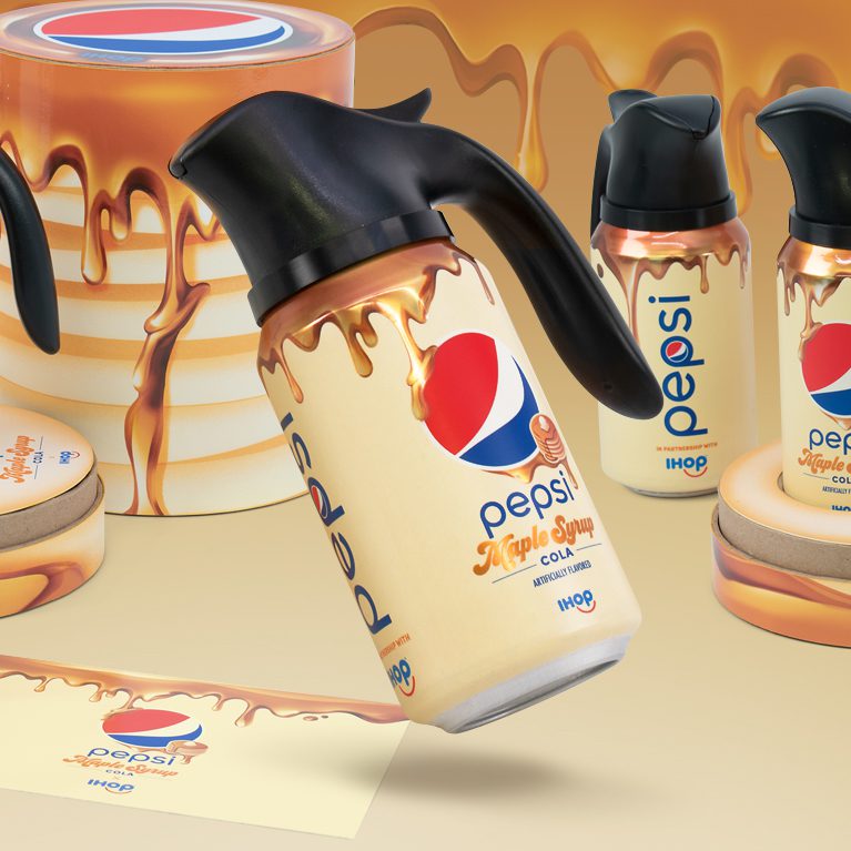 Render of an influencer unboxing experience promoting the limited edition IHOP x Pepsi maple syrup flavor, featuring three cans of cola with custom Pepsi Spouts, inspired by the iconic IHOP syrup pitchers, and a customized note for influencers.