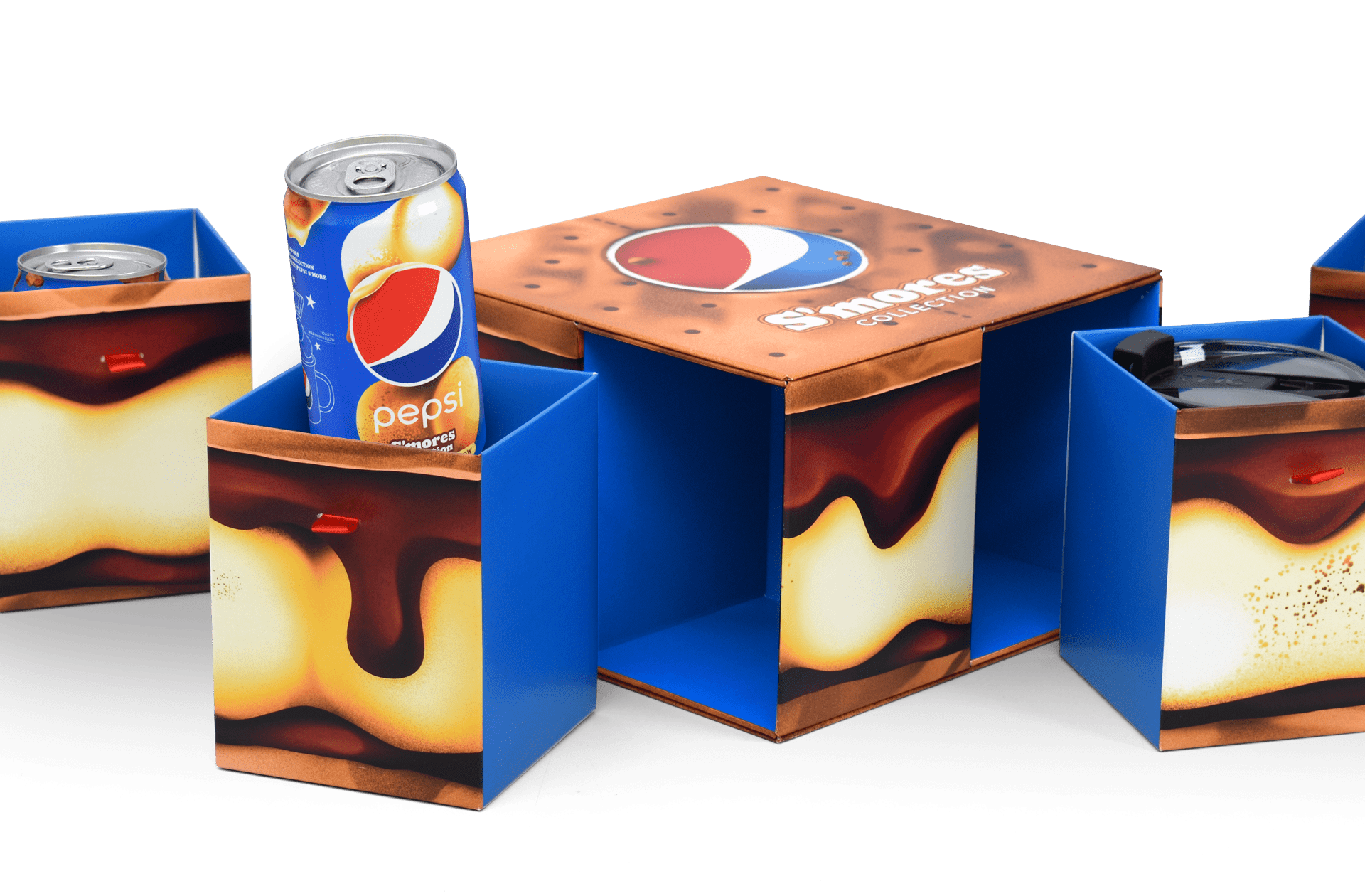 Close-up shot of an Influencer Unboxing Experience promoting the limited time Pepsi S’mores collection, with 4 drawer-like compartments containing cans of pepsi and a custom mug.