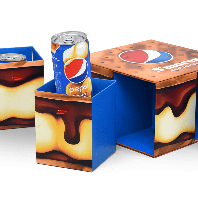 Close-up shot of an Influencer Unboxing Experience promoting the limited time Pepsi S’mores collection, with 4 drawer-like compartments containing cans of pepsi and a custom mug.