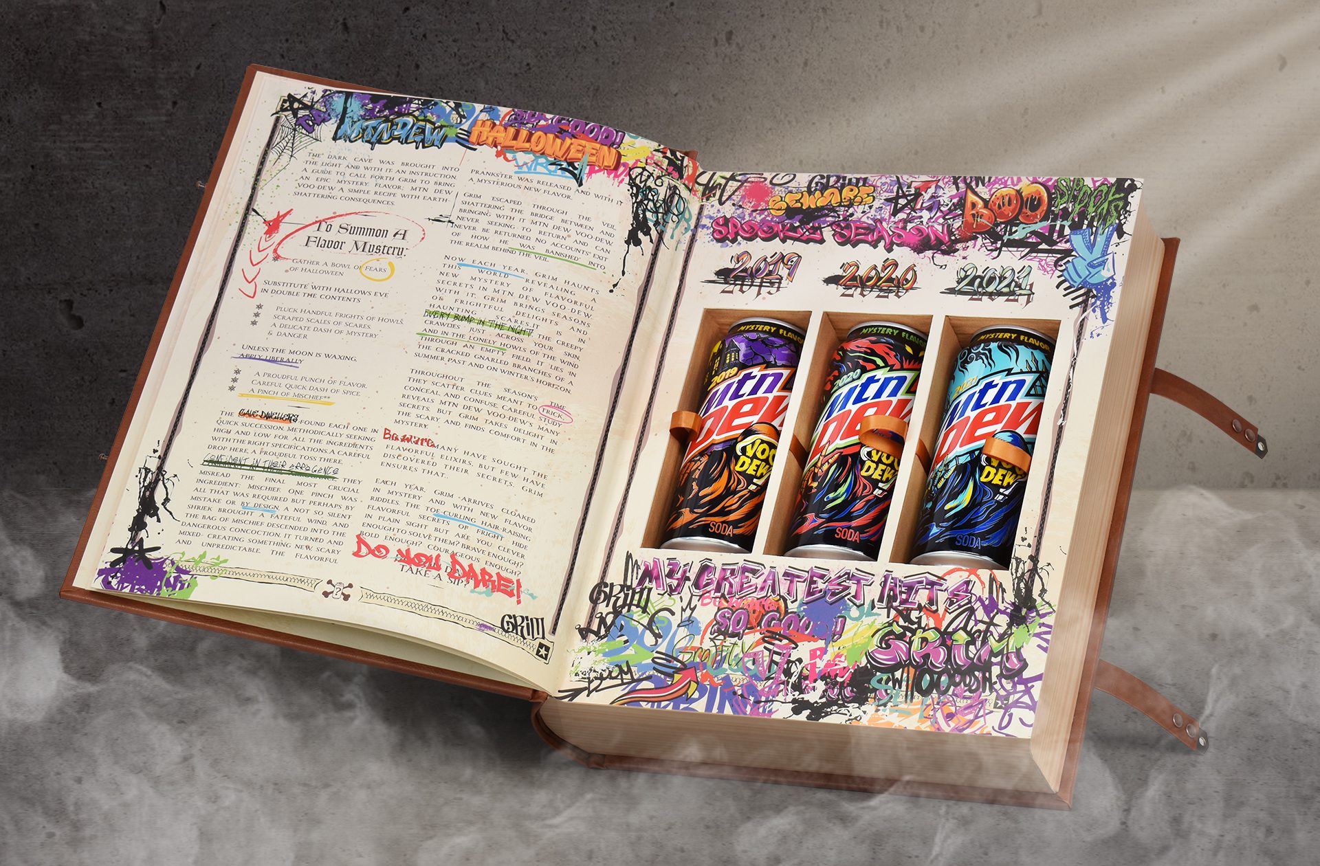 Photograph of the inside of a halloween themed influencer unboxing experience for Mountain Dew Voodew, featuring three cans of limited edition mtn dew flavors.
