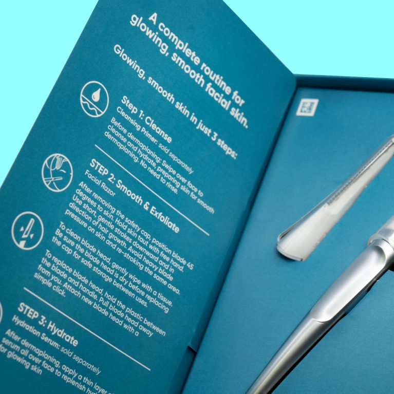 Close up photograph of the inside of an unboxing experience for a dermaplaning at home skincare range by Gillette Venus, showcasing packaging design services for consumer packaged goods.