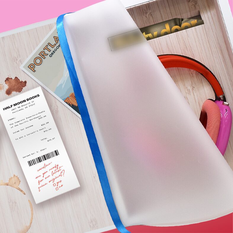 Beauty shot of the interior of an Influencer Unboxing Experience for Misty Door, a Quinn Original audiobook. Quinn heapdhones can be seen inside the kit.