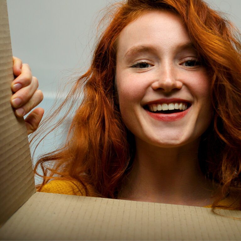 Young woman unboxing a brand activation for a startup company.